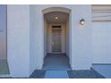 Covered entryway with arched entry and neutral-colored walls at 16405 W Desert Mirage Dr, Surprise, AZ 85388