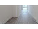 Hallway with gray wood-look tile flooring at 16405 W Desert Mirage Dr, Surprise, AZ 85388