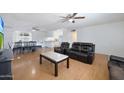 Living room with hardwood floors and black leather furniture at 4833 N 69Th Dr, Phoenix, AZ 85033