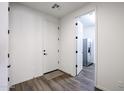 Bright laundry room with wood-look floors, cabinets and a large refrigerator at 7088 W Redbird Rd, Peoria, AZ 85383