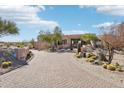 Desert home with circular architecture and manicured desert landscaping at 9853 E Sundance Trl, Scottsdale, AZ 85262