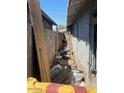 Backyard view with debris along side of house, showing yard's potential for renovation at 1006 S 3Rd Ave, Phoenix, AZ 85003