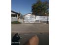 View of exterior with metal fencing surrounding the property and a small home at 1006 S 3Rd Ave, Phoenix, AZ 85003