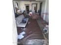 Interior of cluttered living room with a couch, table, and miscellaneous items spread on the floor at 1006 S 3Rd Ave, Phoenix, AZ 85003
