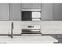 The gourmet kitchen features modern appliances, ample cabinet space and white countertops at 18174 W Pima St, Goodyear, AZ 85338