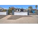 Street view of home with block fence, wrought iron gate, and decorative shrubbery at 2124 W Maricopa St, Phoenix, AZ 85009