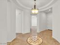 Grand foyer with elegant tile flooring and a decorative ceiling light at 13055 W Eagle Talon Trl, Peoria, AZ 85383