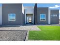 Front entryway features a modern door and a stone walkway at 31559 N Pamela Dr, Queen Creek, AZ 85144