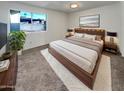 Spacious bedroom with a large bed, wood platform, and plenty of natural light at 1509 N Iowa St, Chandler, AZ 85225