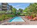 Outdoor pool area with lounge chairs and manicured landscaping at 7117 E Rancho Vista Dr # 4006, Scottsdale, AZ 85251