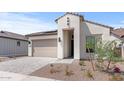 Inviting single-Gathering home with a beige stucco exterior, tile roof, desert landscaping, and a paved driveway at 20306 W Turney Ave, Buckeye, AZ 85396