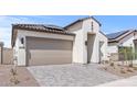 Inviting single-Gathering home with a beige stucco exterior, a tile roof, and a paved driveway at 20306 W Turney Ave, Buckeye, AZ 85396