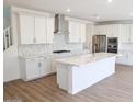 Beautiful kitchen with white cabinets, quartz countertops, a large island, and stainless steel appliances at 2428 W Rowel Rd, Phoenix, AZ 85085