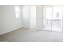 Bright bedroom with neutral carpet and access to a private balcony at 2434 W Rowel Rd, Phoenix, AZ 85085