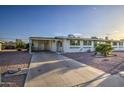 Charming home exterior with long driveway, desert landscaping, and welcoming front entrance at 10619 W Clair Dr, Sun City, AZ 85351
