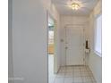 Inviting entryway with neutral tile flooring and a clear view into the adjacent kitchen at 10619 W Clair Dr, Sun City, AZ 85351