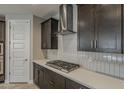 Close-up of a kitchen with stainless steel hood, gas cooktop, white countertops and stylish cabinets at 31969 N 117Th Ave, Peoria, AZ 85383