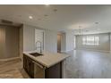 Open-concept living area with neutral walls, tile flooring, recessed lighting, and a view of the backyard at 31969 N 117Th Ave, Peoria, AZ 85383