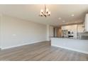 Open-concept living and kitchen space with hardwood floors and plenty of natural light at 32018 N 117Th Ave, Peoria, AZ 85383