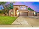 Charming two-story home with a well-manicured lawn, archway and a three car garage at 1201 W Washington Ave, Gilbert, AZ 85233