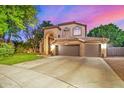 Charming two-story home showcasing a three car garage and desert landscaping at 1201 W Washington Ave, Gilbert, AZ 85233