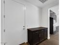 Entryway features a dark wood cabinet for storage and a door to the garage at 1329 W Via De Olivos Dr, San Tan Valley, AZ 85140