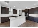 Modern kitchen featuring dark cabinets, a large island, stainless steel appliances, and subway tile backsplash at 1329 W Via De Olivos Dr, San Tan Valley, AZ 85140
