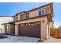Side angle of a two-car garage featuring house numbers and updated exterior lighting at 9239 E Spiral Ave, Mesa, AZ 85212
