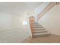 Bright, open living room featuring staircase, neutral carpet, and ample natural light at 695 W Estrella Dr, Gilbert, AZ 85233