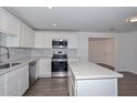 Modern kitchen featuring stainless steel appliances, white cabinets, countertops and a center island at 3801 E Captain Dreyfus Ave, Phoenix, AZ 85032