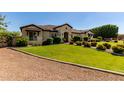 Single-story home featuring a well-maintained lawn and desert landscaping at 19575 E Vallejo St, Queen Creek, AZ 85142