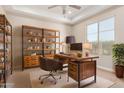 Inviting home office with natural light, custom built-in shelving, and a modern desk at 19575 E Vallejo St, Queen Creek, AZ 85142
