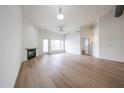 Open living room featuring wood flooring, modern fireplace, and door to another room at 4525 N 22Nd St # 404, Phoenix, AZ 85016