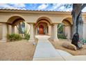 Elegant entryway with arched columns and a large wood door at 10914 E Cinder Cone Trl, Scottsdale, AZ 85262