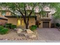 Charming two-story home with beautiful landscaping, a tree, and a paver driveway at 3931 E Crest Ln, Phoenix, AZ 85050