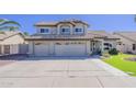 Charming two-story home featuring a three-car garage and desert landscaping at 5249 E Hobart St, Mesa, AZ 85205