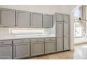 Bright kitchen with gray cabinets, quartz countertop, tile flooring, and a window at 5249 E Hobart St, Mesa, AZ 85205