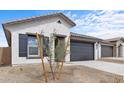 Stylish single-story home with neutral stucco, dark accents, and well-maintained landscaping at 7620 W Minton St, Laveen, AZ 85339