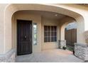 Inviting front porch with stone accents and covered entryway, providing a charming welcome at 2140 W Clearview Trl, Anthem, AZ 85086