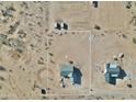 Aerial view of a construction site, showing lot and neighboring homes with a desert landscape and heavy equipment at 25721 W Running Deer Trl, Wittmann, AZ 85361