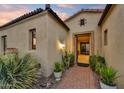 Inviting home entrance features lush desert landscaping and a brick pathway at 2744 S First Water Ln, Gold Canyon, AZ 85118