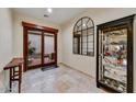 Elegant foyer featuring tile floors, a large arched mirror, and access to the outdoor patio at 2744 S First Water Ln, Gold Canyon, AZ 85118