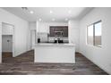 Open concept kitchen with granite counters, stainless appliances, and wood-look flooring at 24579 W St Catherine Ave, Buckeye, AZ 85326
