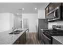 Granite countertops and stainless steel appliances complement this modern kitchen design at 24579 W St Catherine Ave, Buckeye, AZ 85326