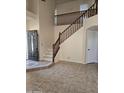 Spacious foyer with beautiful staircase and a stylish front door at 20410 N 51St Dr, Glendale, AZ 85308