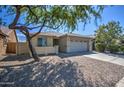 One-story house with a two-car garage and gravel driveway at 29205 N Yellow Bee Dr, San Tan Valley, AZ 85143