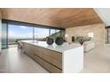 Modern kitchen features a large island, sleek cabinets, and expansive windows showcasing scenic mountain views at 4301 E Upper Ridge Way, Paradise Valley, AZ 85253