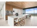 Contemporary kitchen with stainless steel appliances, a large island with bar seating, and scenic outdoor views at 4301 E Upper Ridge Way, Paradise Valley, AZ 85253