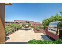 This lovely patio features an outdoor kitchen with stainless grill and a dining set on a stone tiled surface at 7161 E Rancho Vista Dr # 6001, Scottsdale, AZ 85251