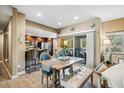 Cozy dining area with a wooden table, seating for four, and bright natural light filtering through the glass doors at 2425 W Bronco Butte Trl # 1002, Phoenix, AZ 85085